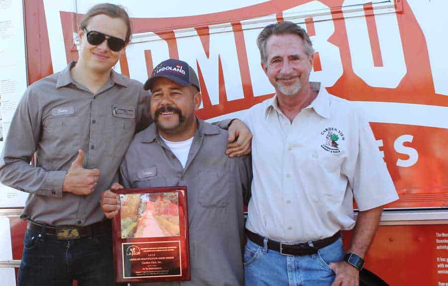 Blake, Thomas, and Mark posing with maintenance award after ceremony