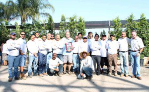Landscape Construction and Design crew posing with award for best unlimited install