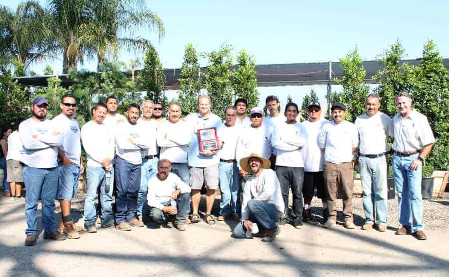 Landscape Construction and Design crew posing with award for best unlimited install
