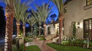 Mediterrannean style front yard with giant palm trees
